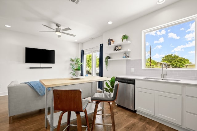 kitchen featuring dishwasher, backsplash, ceiling fan, dark hardwood / wood-style floors, and sink