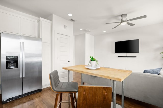 dining area with dark hardwood / wood-style floors and ceiling fan