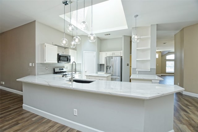 kitchen featuring stainless steel appliances, dark hardwood / wood-style floors, sink, white cabinets, and a center island