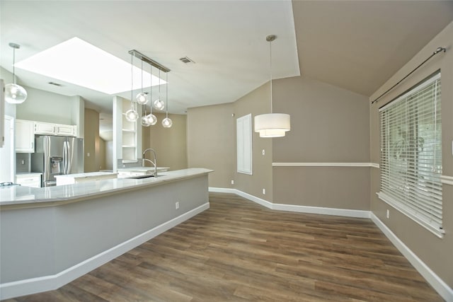 kitchen featuring pendant lighting, dark hardwood / wood-style flooring, sink, and stainless steel fridge with ice dispenser