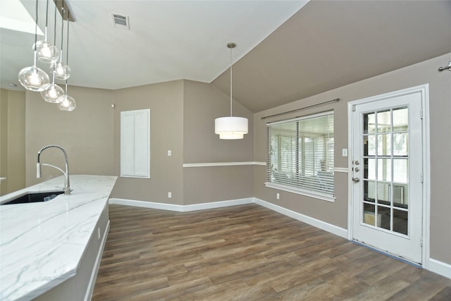 kitchen with dark hardwood / wood-style flooring, pendant lighting, lofted ceiling, and sink