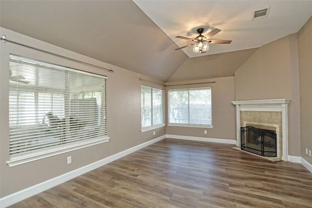 unfurnished living room with dark wood-type flooring, lofted ceiling, ceiling fan, and a fireplace