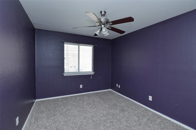 spare room with ceiling fan and carpet floors