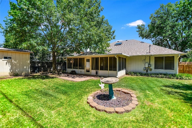 rear view of property with a sunroom and a yard