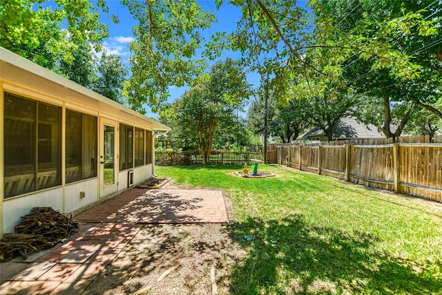 view of yard featuring a patio and a sunroom