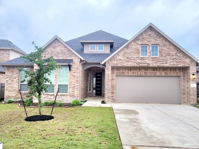 view of front of house featuring a garage and a front lawn