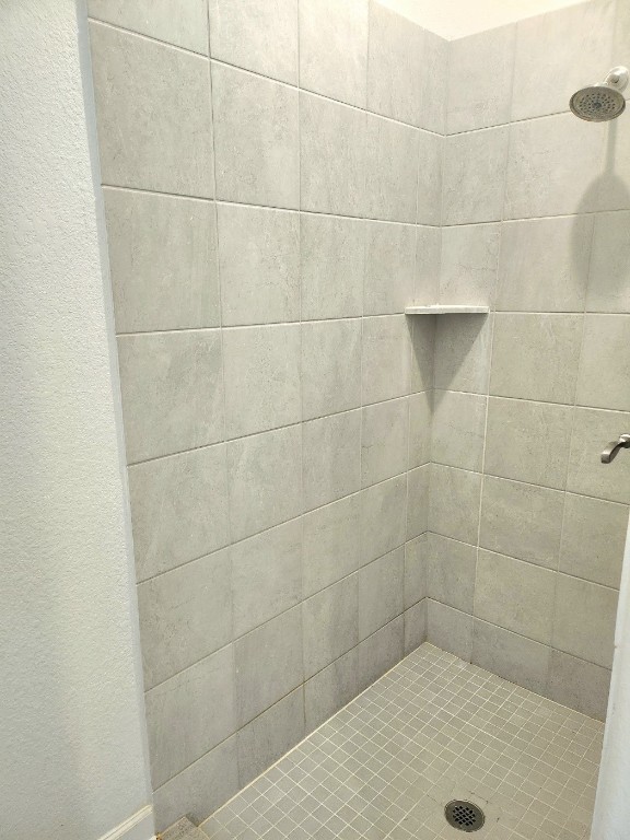 bathroom with tiled shower