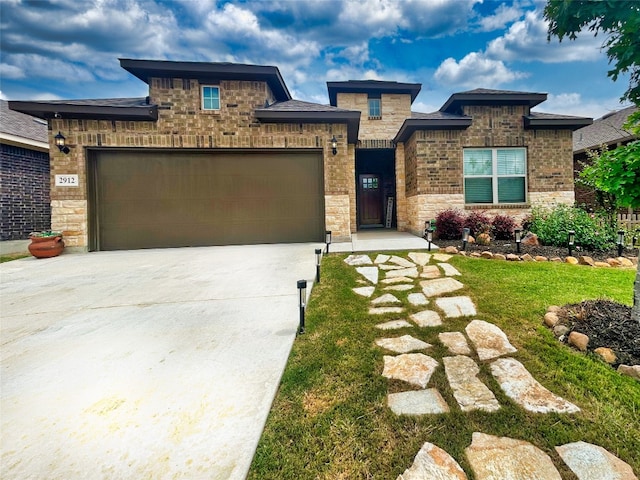 view of front of home with a front yard and a garage