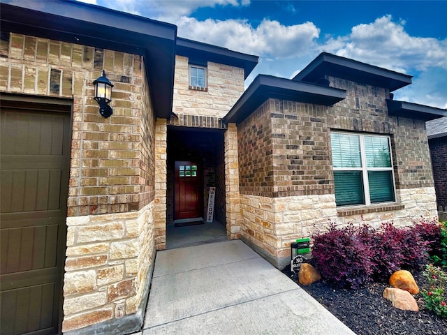 doorway to property featuring a garage