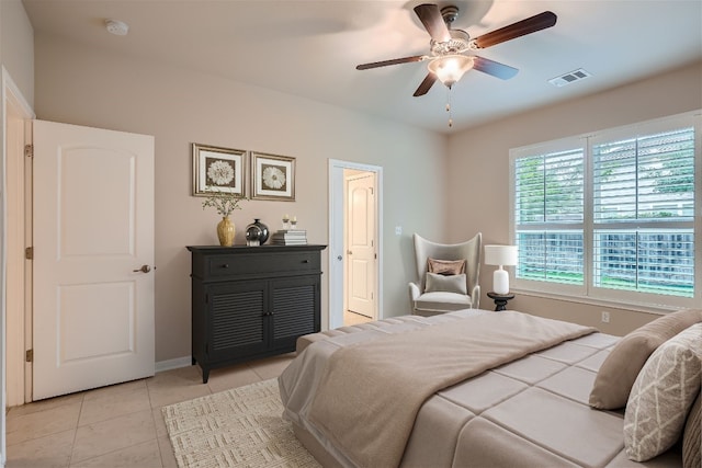 tiled bedroom with ceiling fan