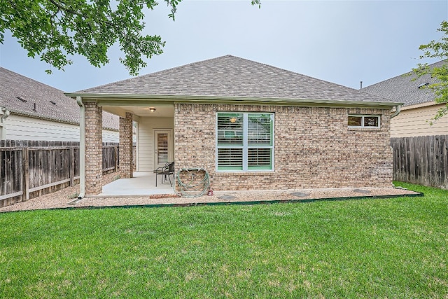 rear view of property featuring a patio and a lawn