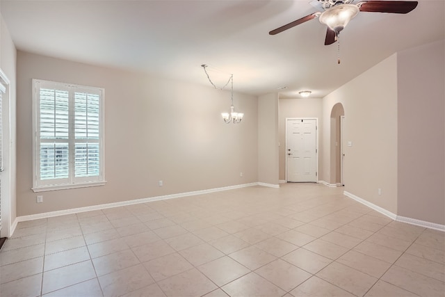 spare room with ceiling fan with notable chandelier and light tile floors