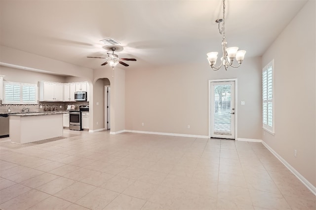 unfurnished living room with light tile flooring and ceiling fan with notable chandelier