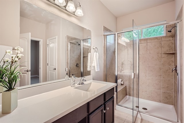 bathroom with walk in shower, vanity, and tile floors