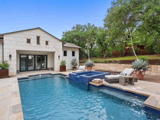 view of pool with an in ground hot tub and a patio