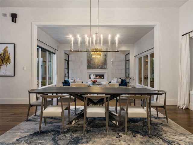 dining room featuring a wealth of natural light, dark hardwood / wood-style floors, and a notable chandelier