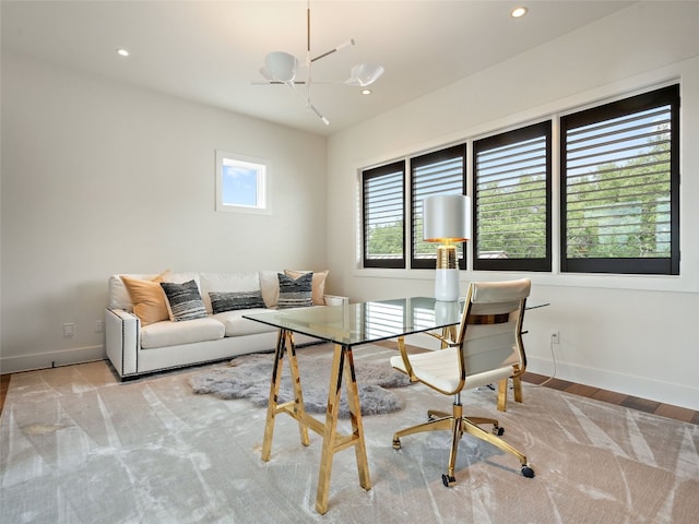 office featuring an inviting chandelier and light hardwood / wood-style floors