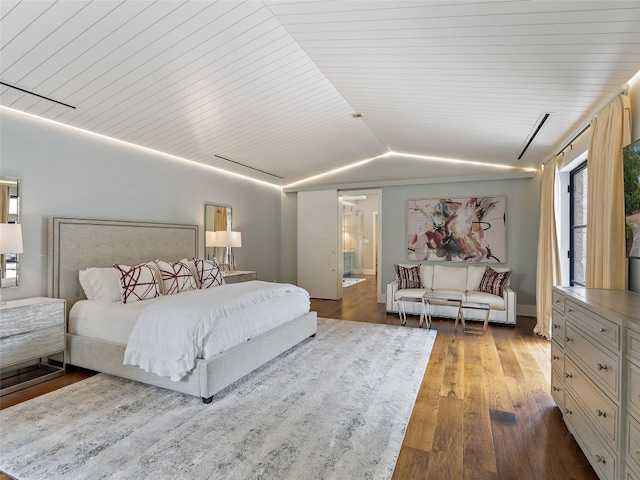 bedroom with lofted ceiling and hardwood / wood-style flooring