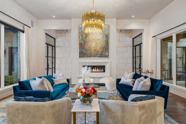 living room featuring wood-type flooring, french doors, tile walls, and a chandelier