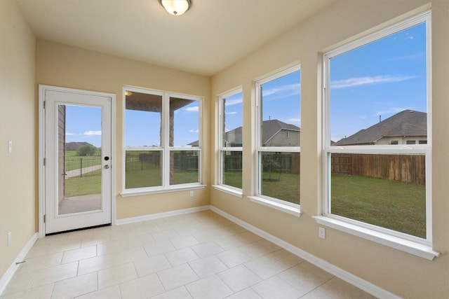 unfurnished sunroom featuring a wealth of natural light