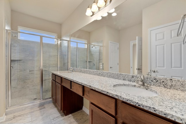 bathroom featuring vanity and a shower with shower door