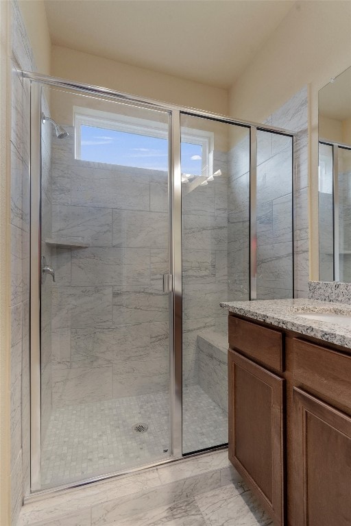 bathroom featuring vanity and an enclosed shower