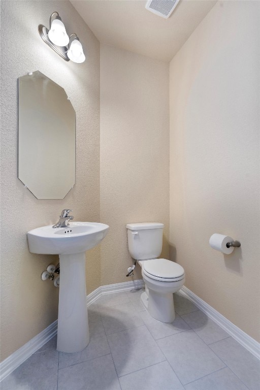 bathroom featuring tile patterned flooring and toilet