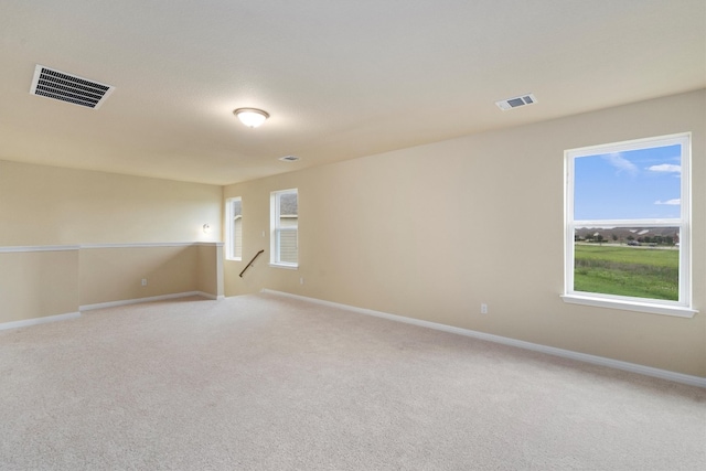 unfurnished room featuring light carpet