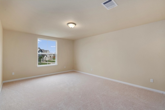 unfurnished room featuring light carpet