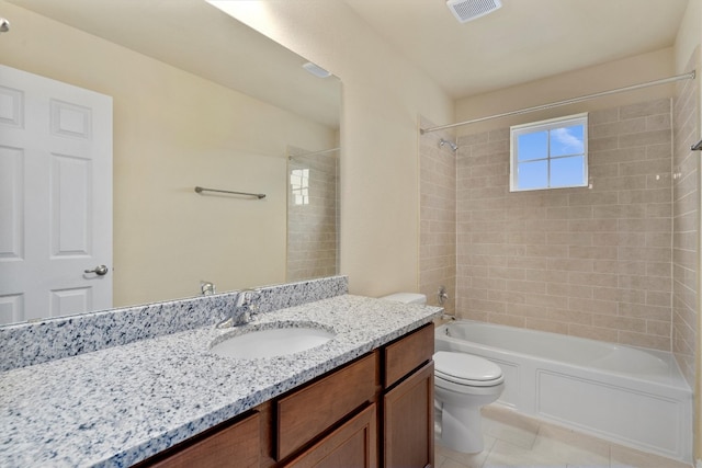 full bathroom with tile patterned flooring, vanity, toilet, and tiled shower / bath combo