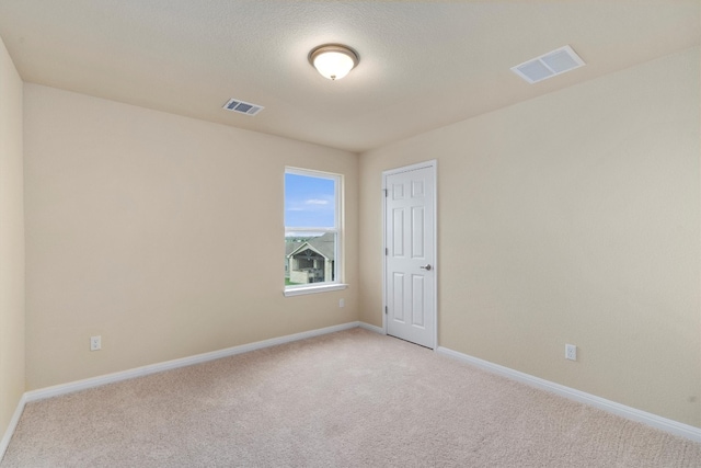 unfurnished room with light carpet