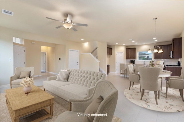 tiled living room with ceiling fan