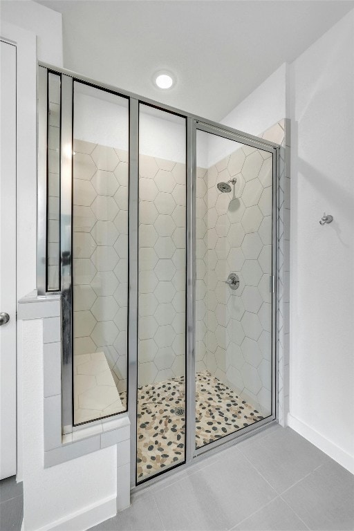 full bathroom with a stall shower and tile patterned floors