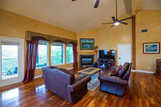 living room featuring hardwood / wood-style flooring, high vaulted ceiling, a wealth of natural light, and ceiling fan