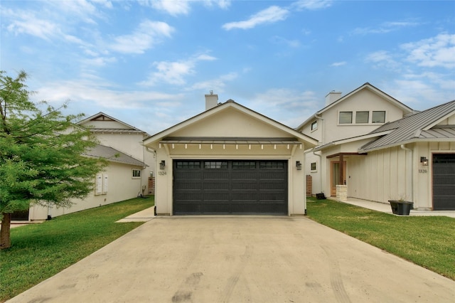 view of front of property with a garage and a front lawn