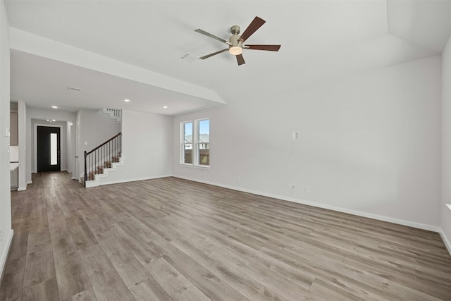 unfurnished living room with light hardwood / wood-style flooring, ceiling fan, and lofted ceiling