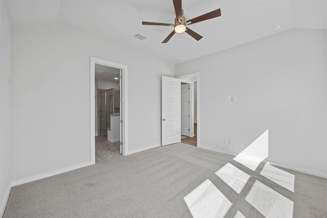 unfurnished bedroom with light colored carpet, lofted ceiling, and ceiling fan