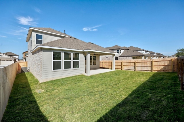 rear view of house with a patio and a lawn