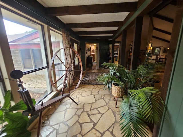 sunroom featuring beamed ceiling