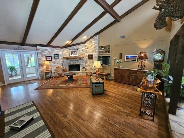 living room featuring french doors, wood-type flooring, beam ceiling, high vaulted ceiling, and a stone fireplace