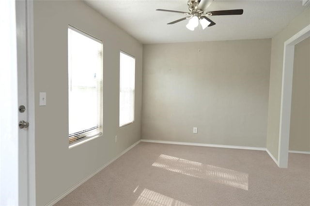empty room with ceiling fan and carpet floors
