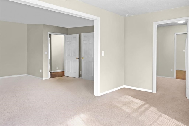empty room featuring carpet and a textured ceiling