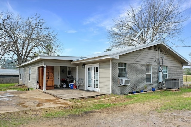 rear view of property with french doors and central AC unit
