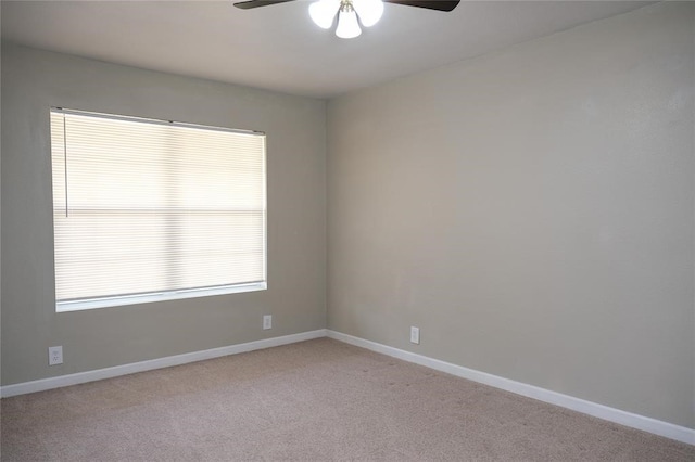 carpeted spare room with ceiling fan