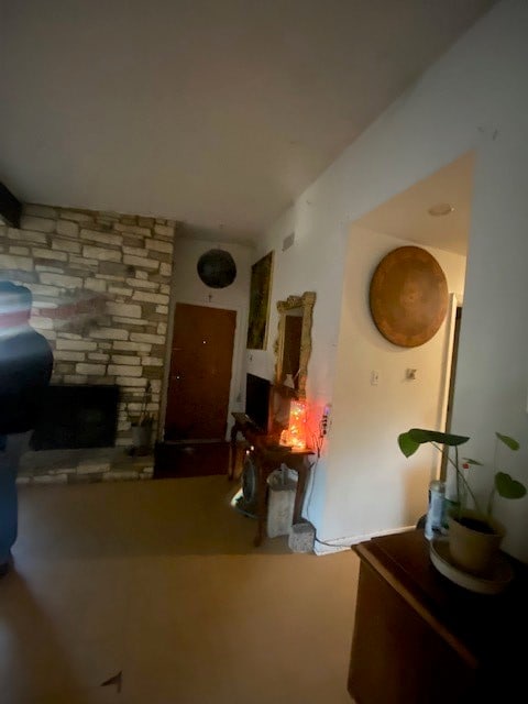 living room featuring a stone fireplace