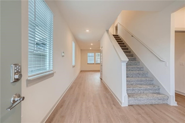 staircase with hardwood / wood-style flooring