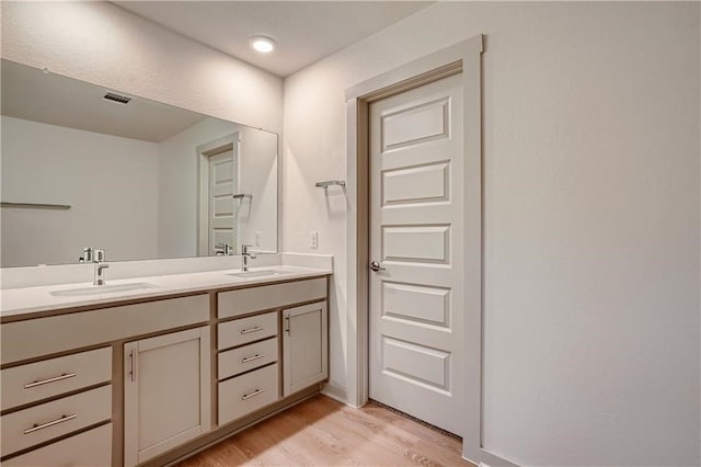 bathroom featuring vanity and hardwood / wood-style flooring