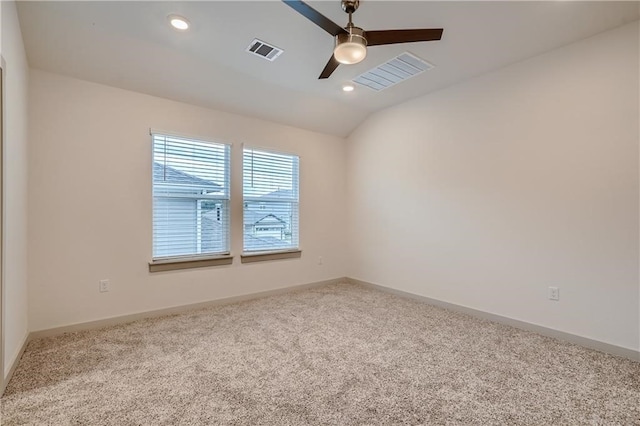 unfurnished room featuring lofted ceiling, light colored carpet, and ceiling fan