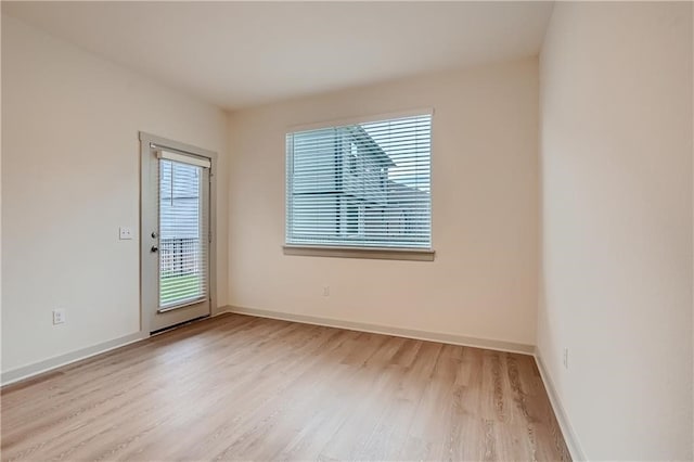 unfurnished room with light wood-type flooring