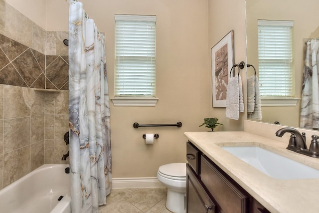 full bathroom featuring a healthy amount of sunlight, tile floors, vanity, and toilet